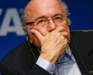 Sepp Blatter motions to underlings to keep their mouths shut!