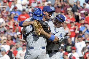 Josh Beckett celebrates with his teammates after recording the final out Sunday. 
