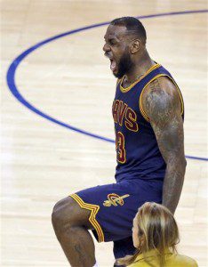 Cleveland Cavaliers forward LeBron James (23) celebrates at the end of the overtime period of Game 2 of basketball's NBA Finals against the Golden State Warriors in Oakland, Calif., Sunday, June 7, 2015. The Cavaliers won 95-93 in overtime. (AP Photo/Eric Risberg)