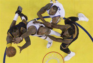 Cleveland Cavaliers forward LeBron James, left, shoots against Golden State Warriors forward Marreese Speights, center, and forward Andre Iguodala, top, during the first half of Game 2 of basketball's NBA Finals in Oakland, Calif., Sunday, June 7, 2015. The Cavaliers won 95-93 in overtime. (AP Photo/Jeff Chiu, Pool)