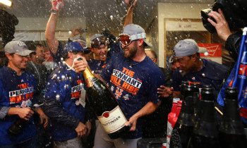 New York Mets players celebrate after Game 4 of the National League baseball championship series against the Chicago Cubs Wednesday, Oct. 21, 2015, in Chicago. The Mets won 8-3 to advance to the World Series. (Elsa/Pool Photo via AP) ORG XMIT: NLCS281