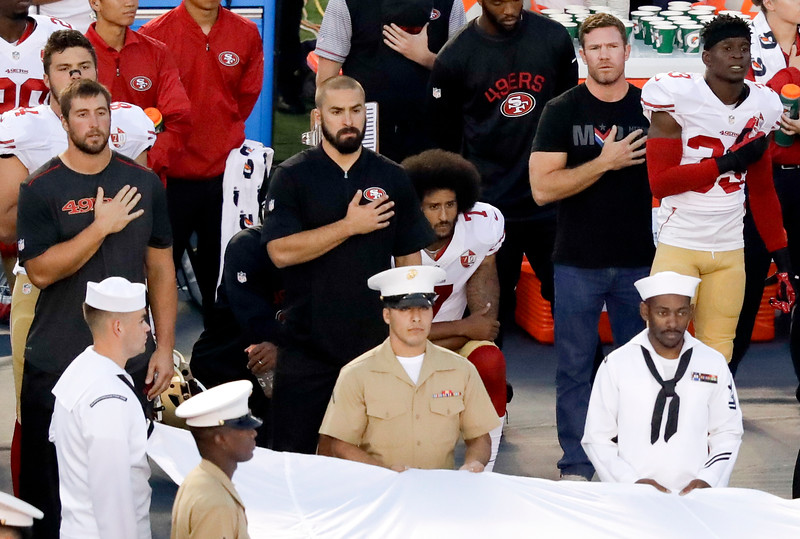 Colin Kaepernick, kneels during the National Anthem Thursday, in San Diego. (AP Photo/Chris Carlson)